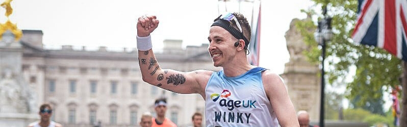Runner waving to crowd